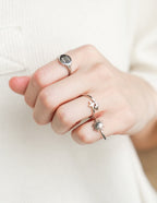 Elevated Faith Christian Jewelry featuring multiple stylish rings worn on a hand