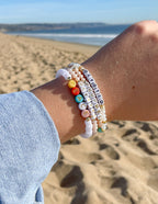Colorful Letter Bracelet Stack on Beach Hand featuring Christian Jewelry Bracelet with uplifting words