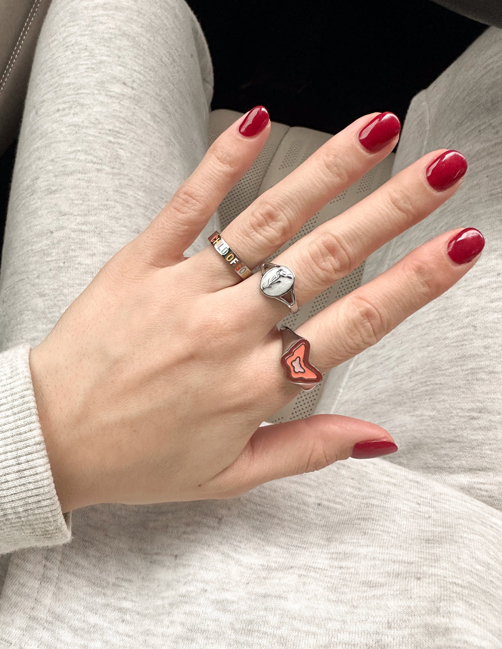 Elevated Faith Christian Jewelry silver ring featuring a unique design on a stylish hand with red nails
