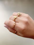 Elegant Elevated Faith gold ring stack featuring symbols in Christian Jewelry style