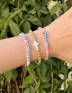Stack of Elevated Faith Christian Jewelry Bracelet featuring colorful beads and a cross charm