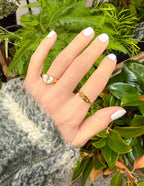 Hand wearing a gold ring with a heart design, featuring Christian Jewelry from Elevated Faith