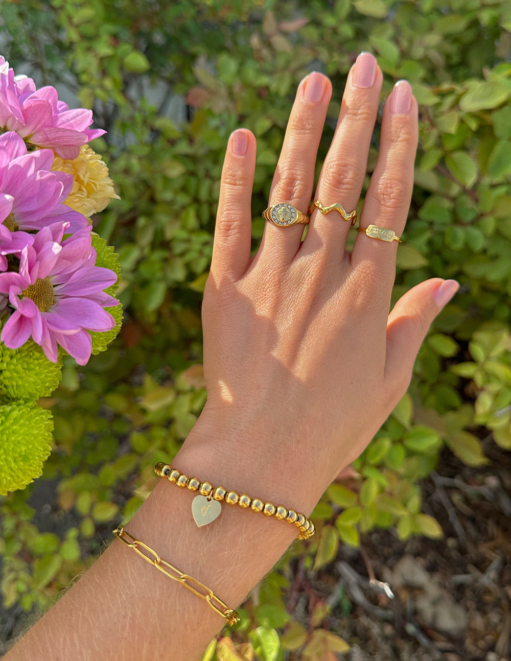 Elevated Faith Christian Jewelry Ring on hand with gold color and floral background