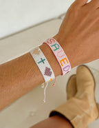 Elevated Faith Christian Jewelry Bracelet with colorful letters and symbols on a woven string design