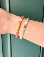 Two Elevated Faith Letter Bracelets featuring a pink and green design, perfect Christian Jewelry Bracelet accessory