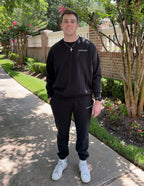 Black Christian Crewneck Sweatshirt from Elevated Faith, styled for a casual outdoor look