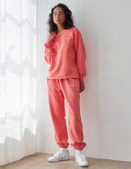 Elevated Faith Christian Crewneck Sweatshirt in coral color paired with matching sweatpants for a casual look