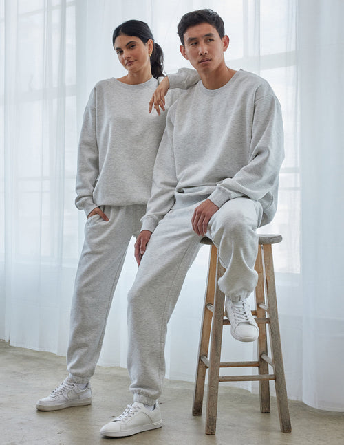 Casual couple wearing Elevated Faith Christian Crewneck Sweatshirt in light gray, styled with matching pants