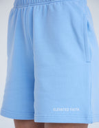 Light blue Elevated Faith shorts featuring side pockets, perfect for everyday casual wear with a Christian theme.
