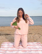 Elegant Elevated Faith Christian Crewneck Sweatshirt in soft pink by the water, paired with matching pants