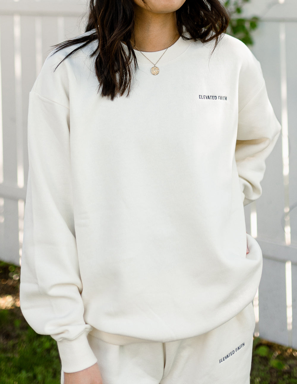 Elevated Faith Christian Crewneck Sweatshirt in soft cream color, perfect for casual wear and comfort