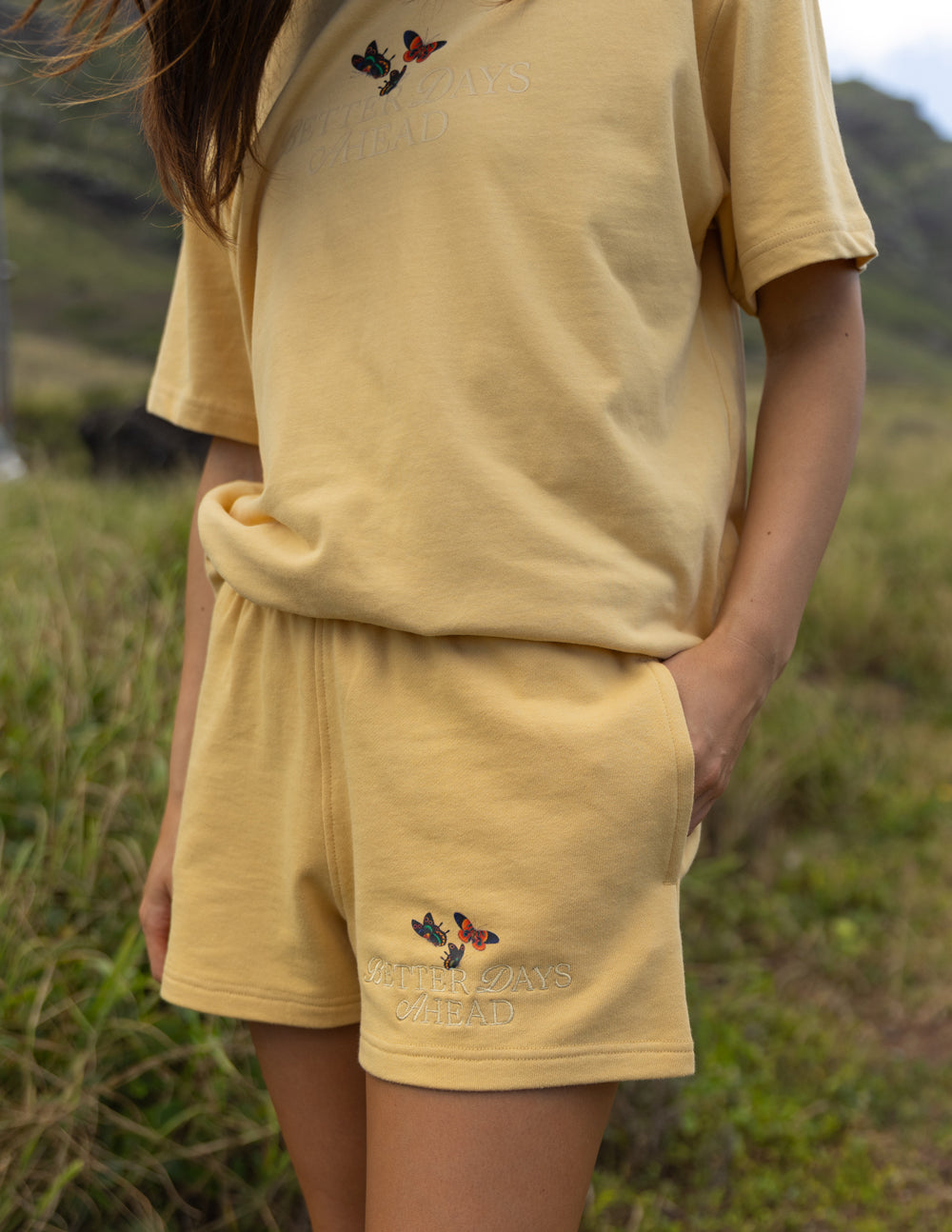 Elevated Faith Christian Shorts in soft yellow with embroidered butterfly design for casual comfort