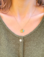 Gold heart pendant necklace from Elevated Faith, a piece of Christian Jewelry worn on a model
