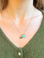 Elevated Faith Christian Jewelry heart necklace with gold and turquoise charms on a model