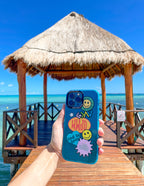Elevated Faith Christian iPhone Case with colorful stickers on a beach pier backdrop