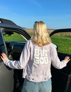 Elevated Faith Christian Jacket in pastel purple with 'BUT GOD' graphic on the back