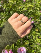 Elevated Faith Christian Jewelry Ring with Silver Design on a Hand Amid Greenery
