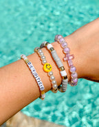 Elevated Faith Christian Jewelry Bracelet set featuring colorful beads and a cross charm on a wrist