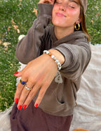 Elevated Faith Stone Christian Jewelry Bracelet worn on hand with red nails and casual outfit