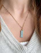 Elevated Faith Christian Jewelry Gold Necklace with Blue Pendant on a Model