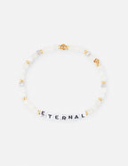 Elevated Faith Christian Jewelry Bracelet featuring white beads and black letter beads spelling ETERNAL