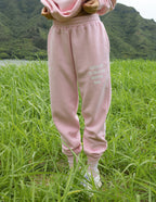 Elevated Faith pink sweatpants featuring 'God is Always With Me' text, perfect for Christian Apparel style