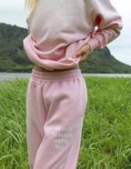 Pink Elevated Faith sweatpants with 'God is always with me' text, perfect for Christian apparel lovers