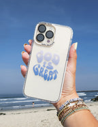 Elevated Faith Christian iPhone Case with the text 'God is Great' on a beach background