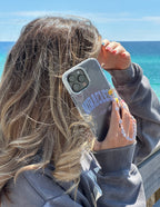 Elevated Faith Christian iPhone Case with a trendy design showcased by a woman at the beach