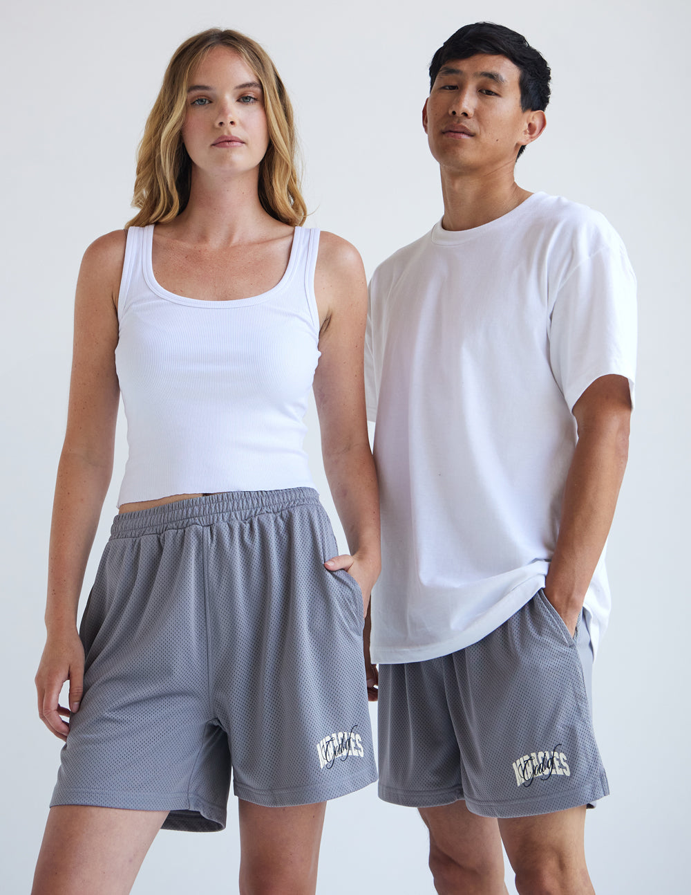 Couple wearing Elevated Faith Christian Shorts in gray with pockets and a comfortable fit
