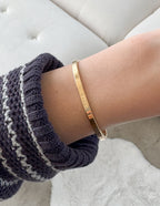 Elevated Faith Christian Jewelry Bracelet in gold worn on wrist for stylish faith expression