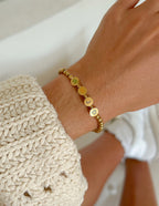 Elevated Faith Christian Jewelry Bracelet with gold letter beads spelling W J D on a wrist