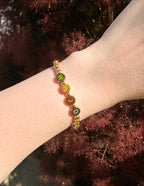 Elevated Faith Christian Jewelry Bracelet with colorful letter beads spelling 'WWJD' on a gold band