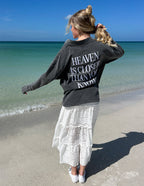 Elevated Faith Christian Jacket with 'Heaven is Closer Than You Know' printed on the back, worn at the beach