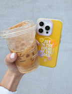 Christian iPhone Case with Bright Yellow Design and Inspirational Quote, Held with a Iced Coffee