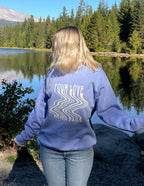 Woman wearing a blue Christian Crewneck Sweatshirt with 'Your Love Never Fails' design by Elevated Faith