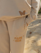 Elevated Faith cream sweatpants featuring 'Made New' design, perfect for Christian Apparel enthusiasts
