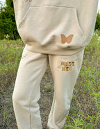 Elevated Faith beige sweatpants featuring 'Made New' design, part of Christian Apparel collection
