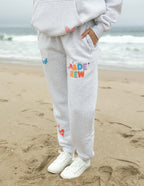 Elevated Faith gray sweatpants with colorful 'Made New' design, perfect for Christian Apparel enthusiasts