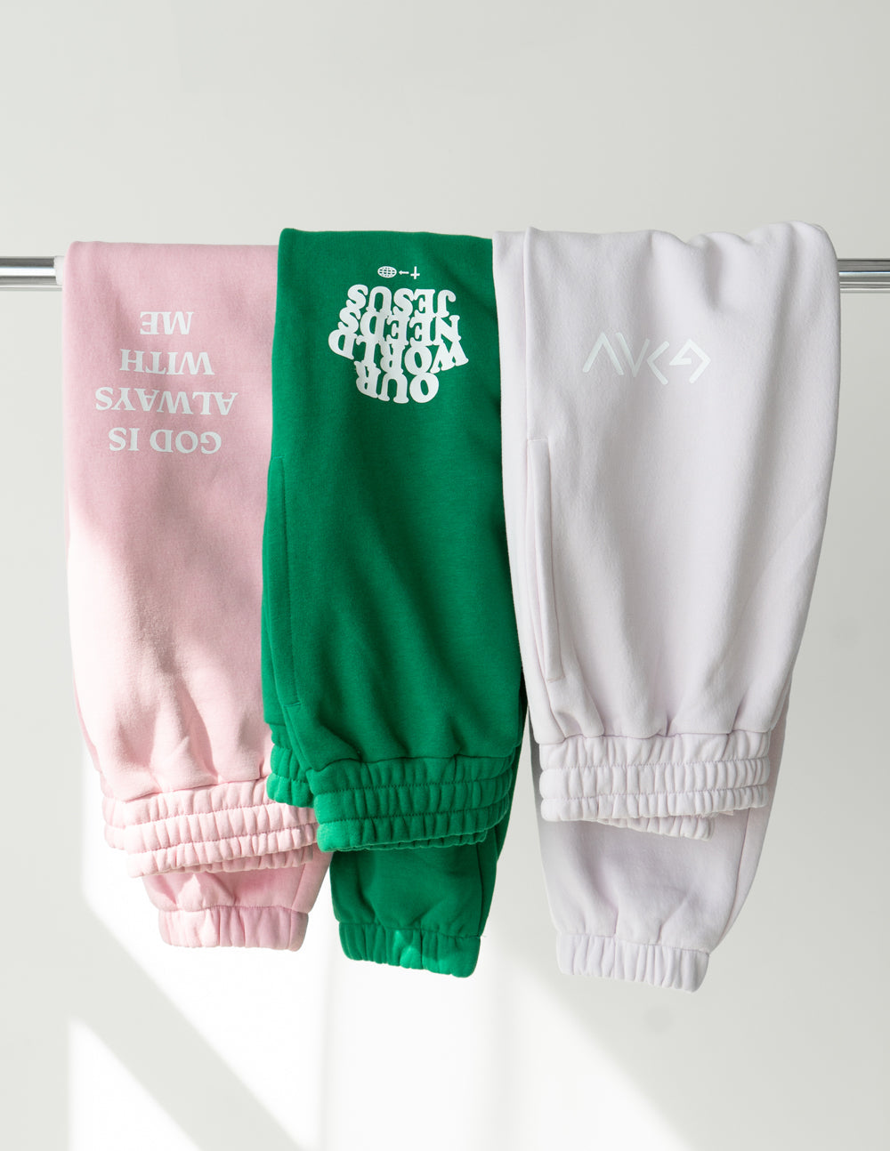Elevated Faith Christian Apparel Sweatpants in pink, green, and white with inspirational graphics