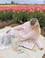 Elevated Faith Tumbler among colorful tulips, perfect for Christian gifts and enjoying peaceful moments