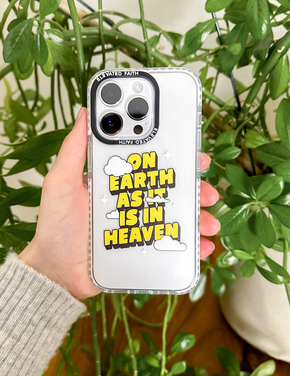 Elevated Faith Christian iPhone Case with the quote 'On Earth as it is in Heaven' and cloud graphics