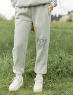 Elevated Faith Green Sweatpants with 'Perfect Love' Design for Christian Apparel Comfort