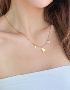 Gold Christian Jewelry Necklace featuring a cross, dove, and heart charms on a delicate chain