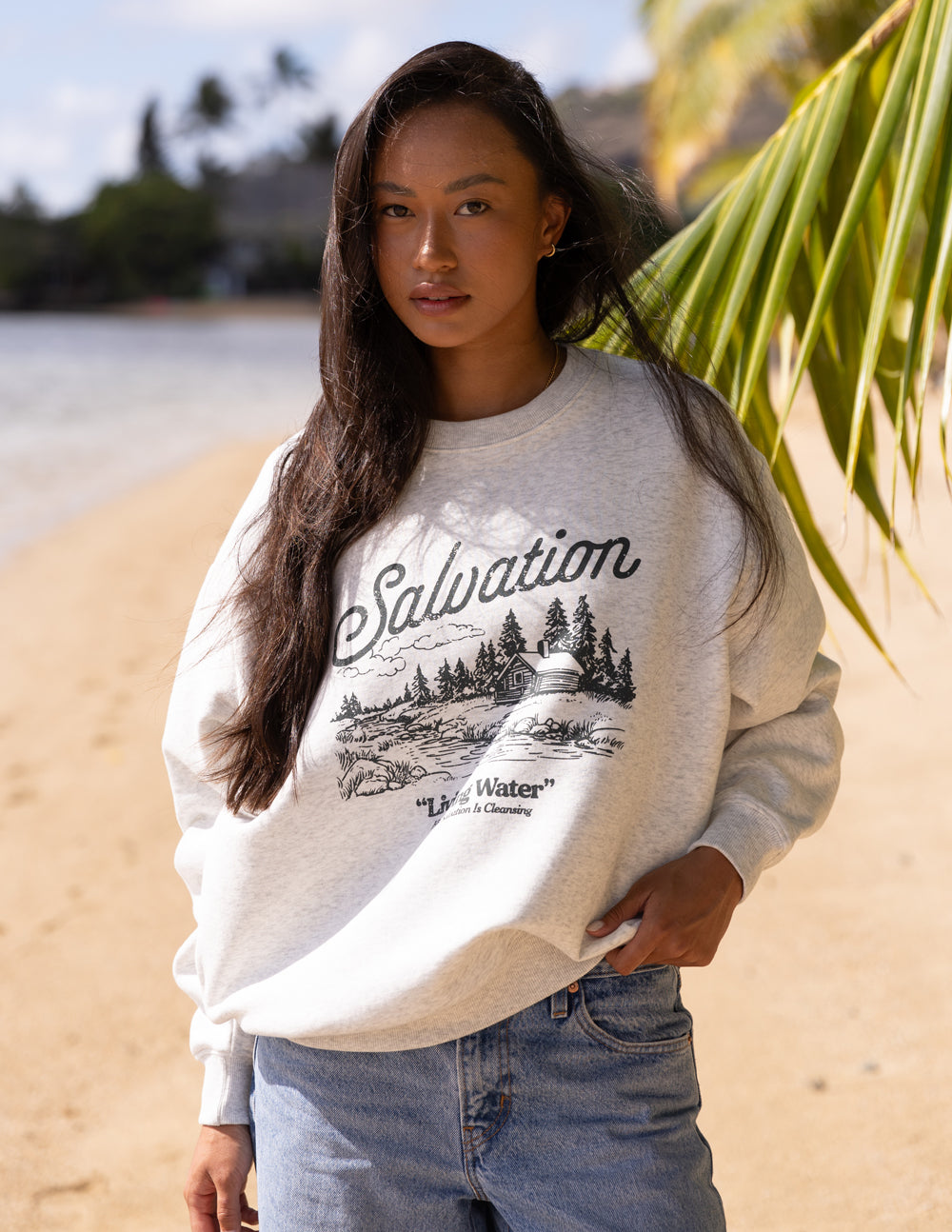 Elevated Faith Christian Crewneck Sweatshirt with 'Salvation' design in a casual beach setting