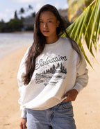 Elevated Faith Christian Crewneck Sweatshirt with 'Salvation' design in a casual beach setting