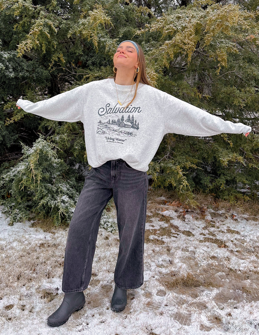 Model wearing Elevated Faith Christian Crewneck Sweatshirt featuring a stylish winter design outdoors
