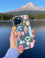 Elevated Faith Christian iPhone Case with colorful stickers and nature backdrop