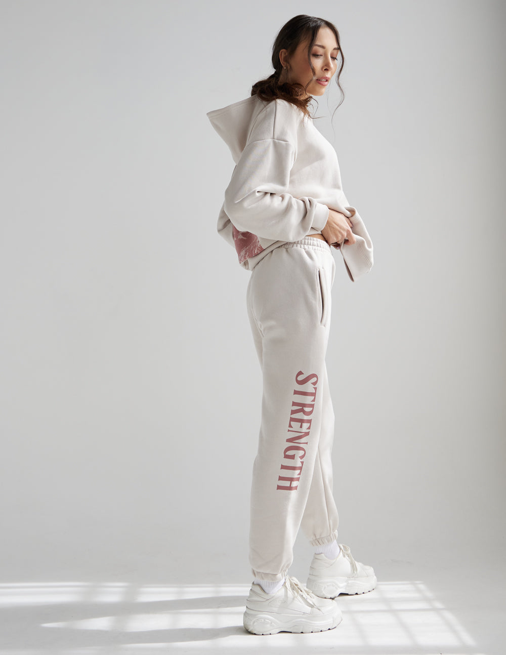 Elevated Faith Sweatpants in Light Beige with 'Strength' Text, Perfect for Christian Apparel