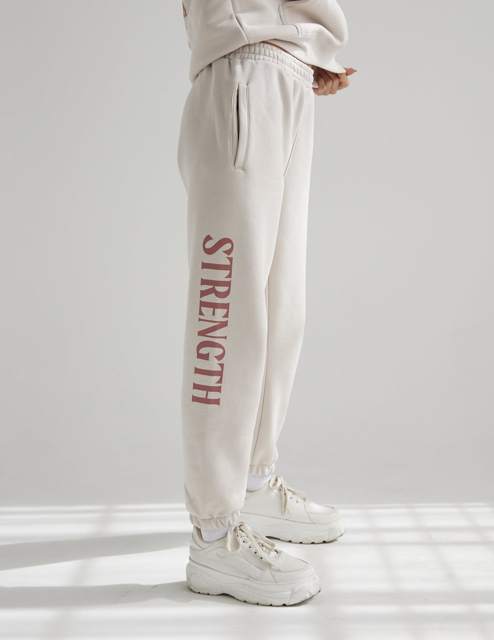 Elevated Faith Sweatpants in Light Beige with 'Strength' Print, Perfect for Christian Apparel Wear